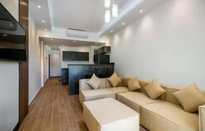 a living room with a couch and a table at Al Saraya Sahl Hasheesh by Peak -One-Bedroom Apartment C316 in Hurghada