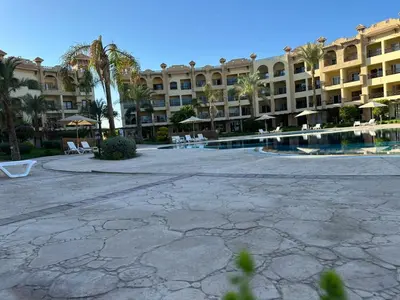 a large building with a courtyard with a swimming pool at Al Saraya Sahl Hasheesh by Peak -One-Bedroom Apartment C316 in Hurghada