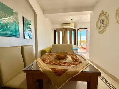 a dining room table with a bowl on top of it at Exquisite 1BR Chalet with Pool and Beach Front El Gouna in Hurghada