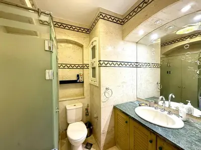 a bathroom with a toilet and a sink at Exquisite 1BR Chalet with Pool and Beach Front El Gouna in Hurghada