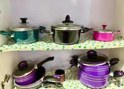 three pots and pans on a shelf in a kitchen at Exquisite 1BR Chalet with Pool and Beach Front El Gouna in Hurghada