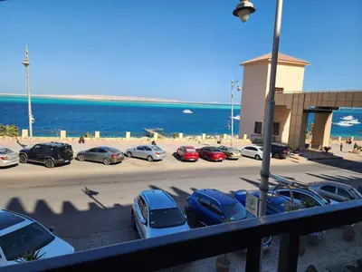 a group of cars parked in a parking lot next to the ocean at Studio for rent in Hurghada 116 in Hurghada