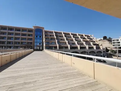 a boardwalk leading to a large apartment building at Studio for rent in Hurghada 116 in Hurghada