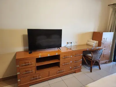 a wooden desk with a television on top of it at Studio for rent in Hurghada 116 in Hurghada