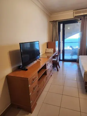 a room with a desk with a television and a bed at Studio for rent in Hurghada 116 in Hurghada