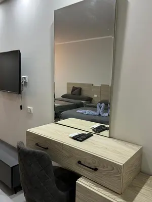 a dressing table with a mirror and a chair at Scandic Resort Hurghada in Hurghada