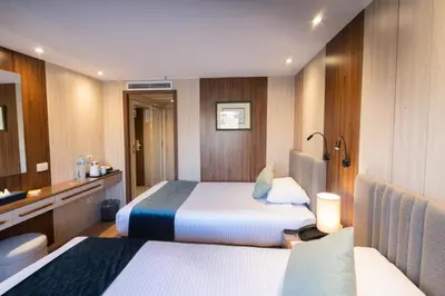 a hotel room with two beds and a bathroom at Renaissance Nile Cruise - Every Saturday from Luxor To Aswan for 4 Nights , and every Wednesday from Aswan To Luxor for 3 Nights in Luxor