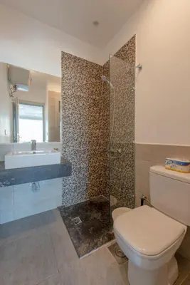 a bathroom with a toilet and a shower and a sink at Modern 1BR with Pool View in Sholan El Gouna in Hurghada