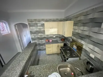 a small kitchen with a sink and a stove at Tokyo House Luxor in Luxor