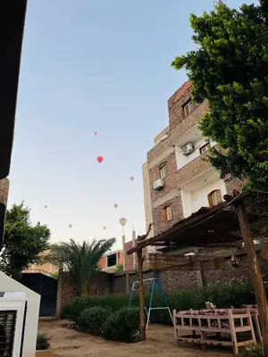 a building with a playground in front of it at Tokyo House Luxor in Luxor