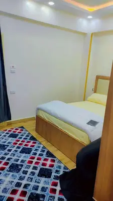 a bedroom with two beds and a rug at Carrefour Hurghada city centre in Hurghada
