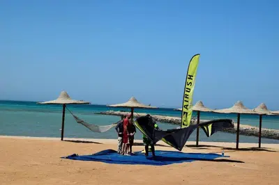 a couple of people standing on a beach with a kite at Impeccable 1-Bed Apartment in Hurghada in Hurghada