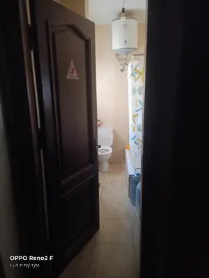 an open door to a bathroom with a toilet at happy vacation in Hurghada