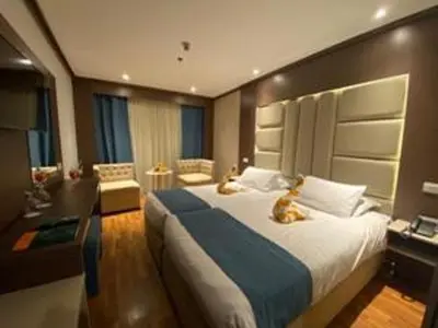 a bedroom with a large bed with two animals laying on it at King of The Vally Nile Cruise Aswan To Luxor 3 Night And visit the Nubian village in Aswan