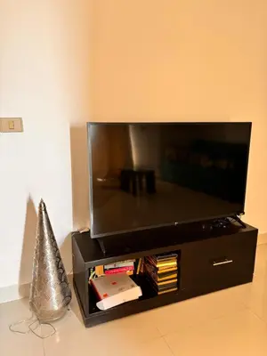 a flat screen tv sitting on top of a black stand at A dream with a sea view in Azzurra in Hurghada