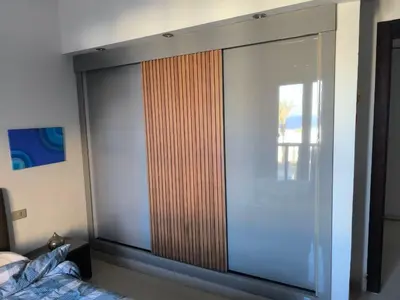a large sliding glass door in a bedroom at A dream with a sea view in Azzurra in Hurghada