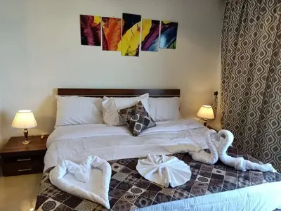 a bedroom with a large bed with towels on it at Sea View Hurghada Holiday Home in Hurghada