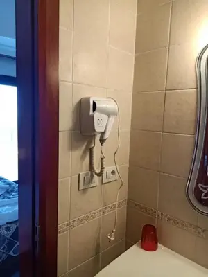a bathroom with a phone on the wall next to a toilet at Sea View Hurghada Holiday Home in Hurghada