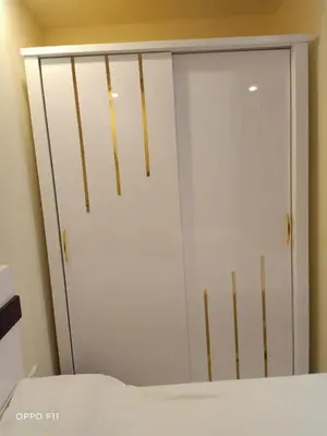 a white closet with a mirror next to a bed at ميراج باى in Hurghada