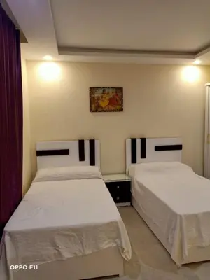 a bedroom with two beds and a painting on the wall at ميراج باى in Hurghada