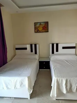 two beds sitting next to each other in a room at ميراج باى in Hurghada
