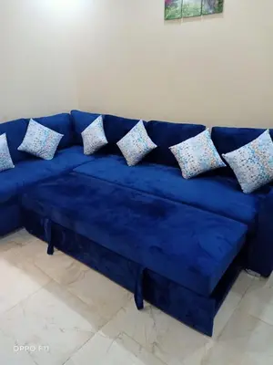 a blue couch with pillows on it in a room at ميراج باى in Hurghada