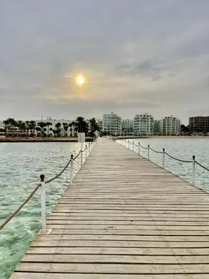a wooden pier in the middle of the water at Scandic Resort Hurghada in Hurghada