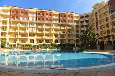 a large swimming pool in front of a building at Florenza Khamsin Apartments in Hurghada