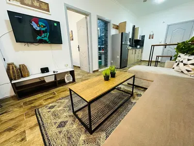a living room with a couch and a table at Cleopatra Style City Center in Hurghada