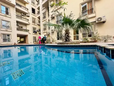 a large blue swimming pool in front of a building at Cleopatra Style City Center in Hurghada