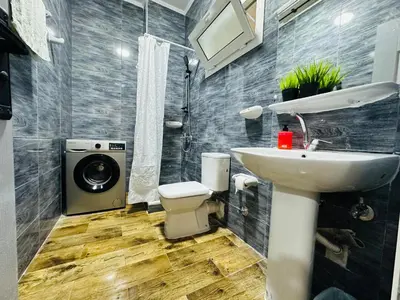 a bathroom with a sink and a washing machine at Cleopatra Style City Center in Hurghada