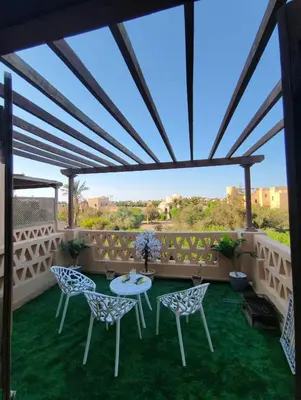 a patio with a table and chairs on a roof at Rihana 2 bedrooms in Hurghada