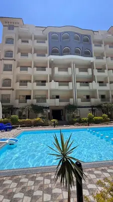 a large apartment building with a large swimming pool at Florenza khamsin Resort in Hurghada