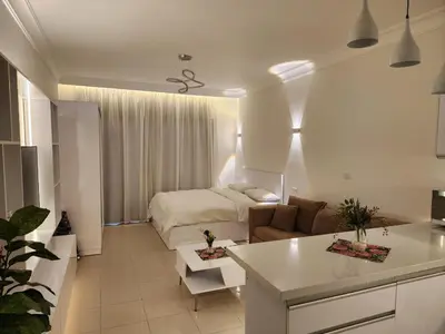 a white living room with a bed and a couch at Studio for rent in the view 607 in Hurghada