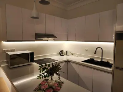 a kitchen with white cabinets and a microwave at Studio for rent in the view 607 in Hurghada