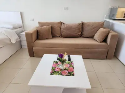 a living room with a couch and a table with a cake at Studio for rent in the view 607 in Hurghada