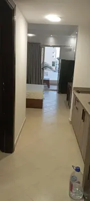 a bedroom with a bed and a room with a floor at Florenza Resort in Hurghada