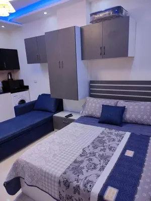 a bedroom with a bed and a couch at Casablanca Beach for families only in Hurghada
