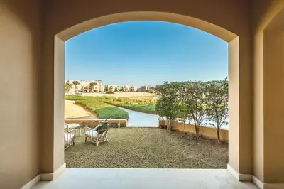 an open door to a patio with a view of the water at The 2BDR Warmhearted Waterside Apt in Hurghada