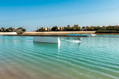 a person on a paddle board in the water at The 2BDR Warmhearted Waterside Apt in Hurghada