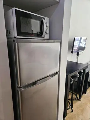 a microwave sitting on top of a refrigerator at Sheraton Plaza 218 in Hurghada
