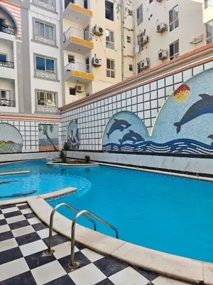 a swimming pool in front of a building at Sheraton Plaza 218 in Hurghada