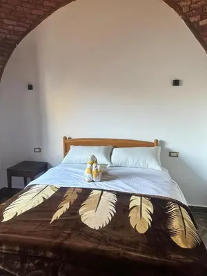 a bed with two teddy bears sitting on it at ZAIN PALACe in Jazīrat al ‘Awwāmīyah