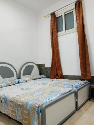 a bedroom with a bed and a window at الغردقه منطقه الاحياء in Hurghada