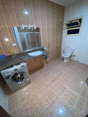 a bathroom with a sink and a washing machine at Villa with private pool A F in Hurghada