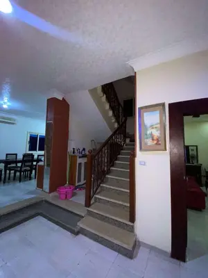a living room with stairs and a dining room at Villa with private pool A F in Hurghada