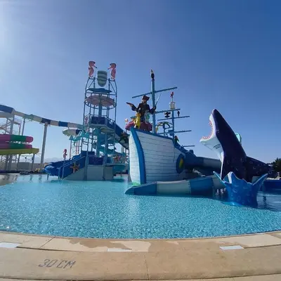 a group of people on a water slide in a water park at Oasis Apartment in Safaga
