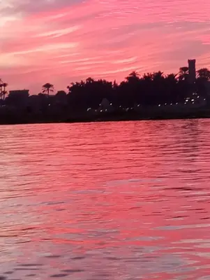 a sunset over a body of water at Studio House Luxor in Luxor