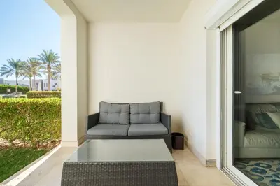 a living room with a couch on a patio at Joubal 2BR • Premium Ground Floor in Hurghada