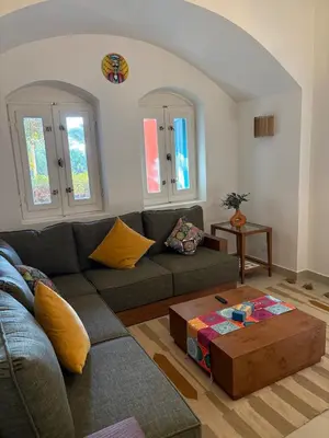 a living room with a couch and a coffee table at Cozy 1BR in the Heart of Gouna in Hurghada